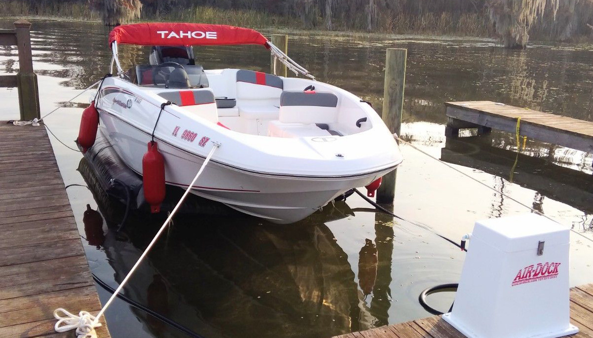 row2 White v-hull boat on Air-Dock boat lift